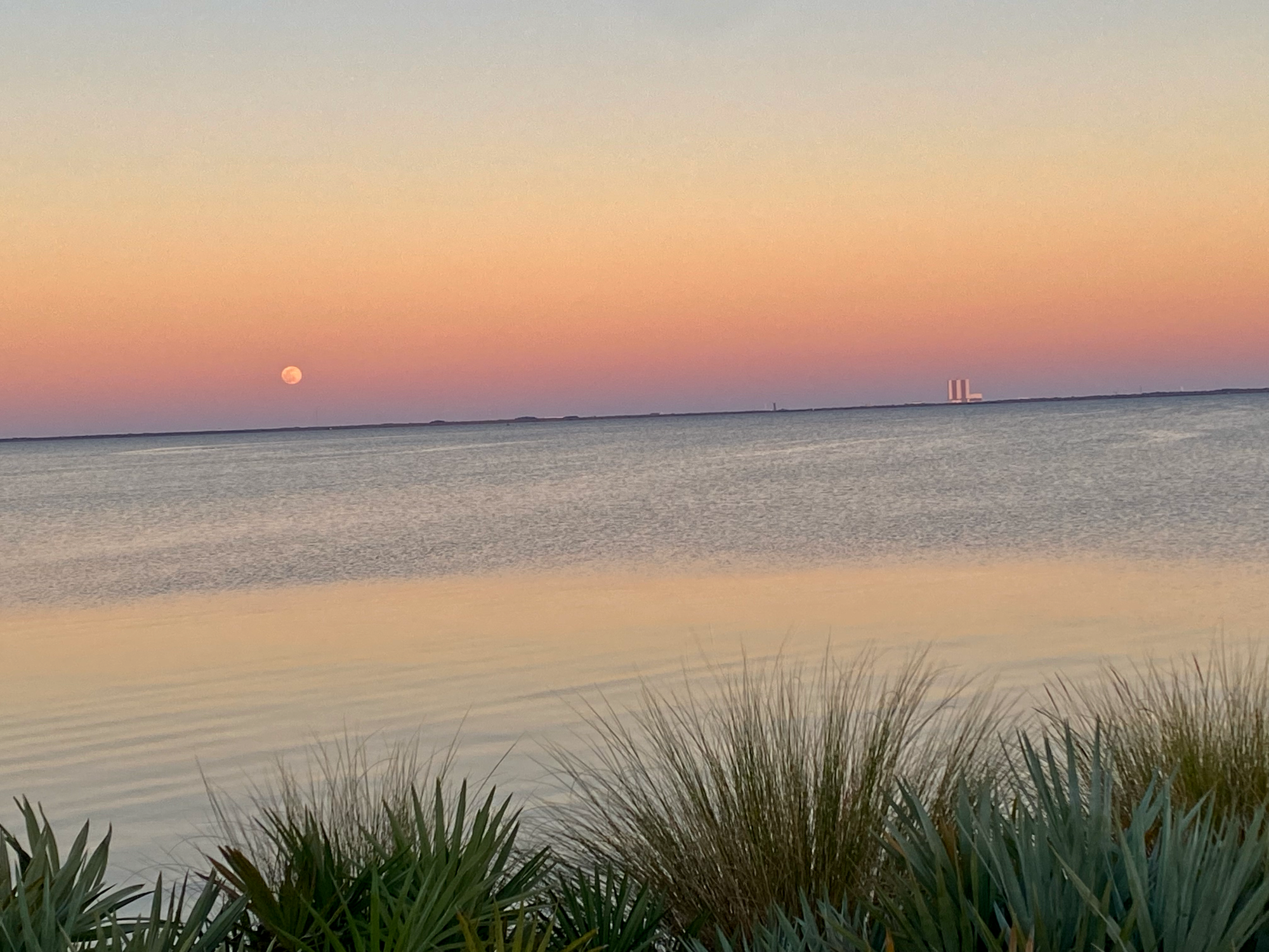 Indian River Lagoon at sunset. Full Moon on the left and Cape Canaveral launchpad on the right.
