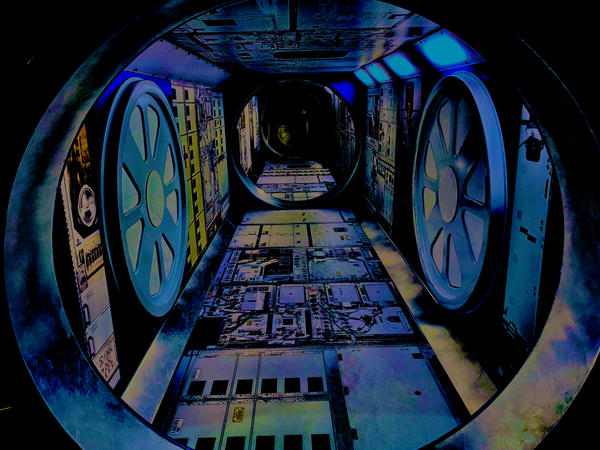 Close up of a tubular space station as seen from a porthole.