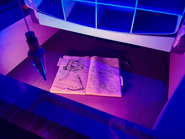 Photograph of an engineer’s journal in his living quarters in space.