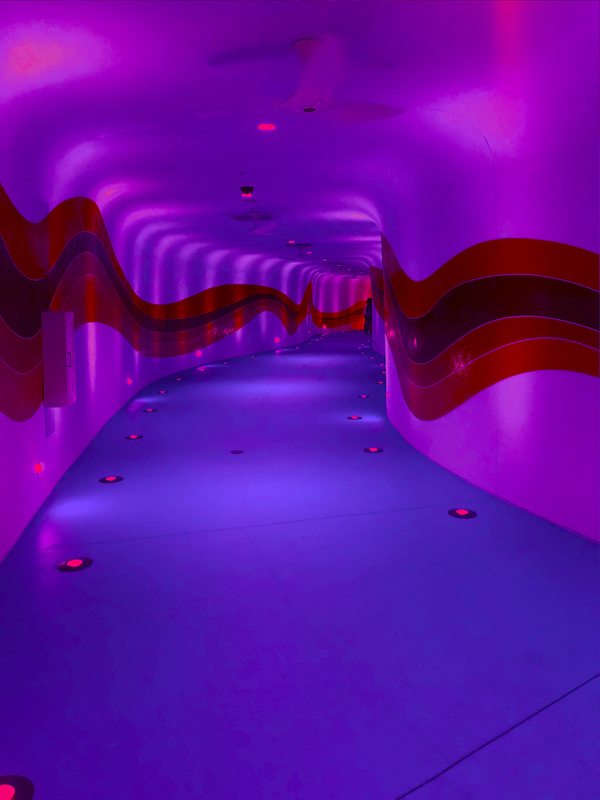 Futuristic impression of a long tunnel, curved hallway. 